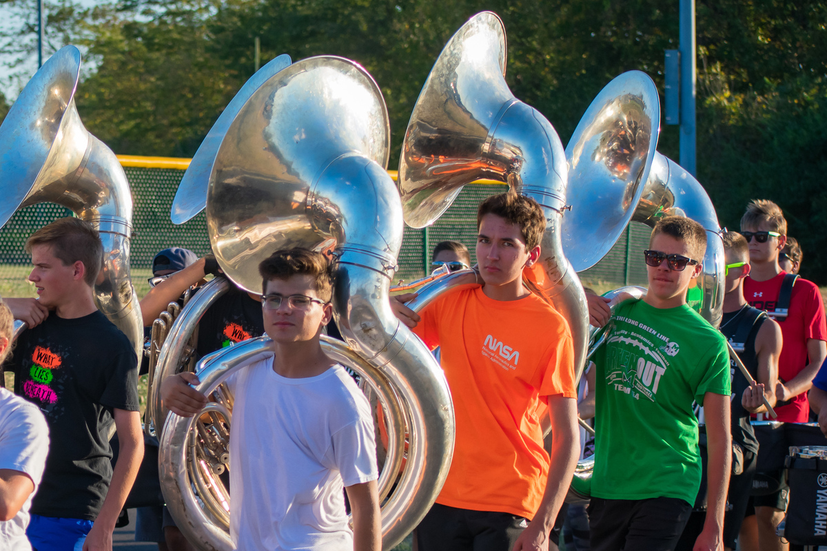 students holding tubas